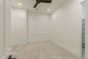 Carpeted empty room with ceiling fan