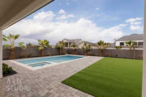 View of swimming pool with an in ground hot tub