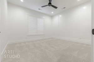 Carpeted spare room featuring ceiling fan