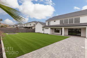 Rear view of property featuring a lawn