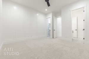 Carpeted empty room featuring ceiling fan