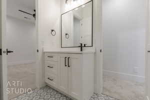 Bathroom featuring vanity and ceiling fan