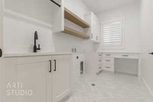 Washroom featuring cabinets, sink, hookup for a washing machine, hookup for an electric dryer, and light parquet flooring