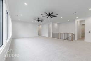 Empty room featuring light carpet and ceiling fan