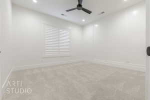 Empty room featuring ceiling fan and light colored carpet