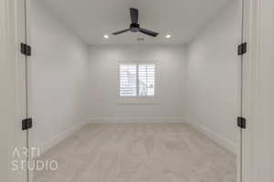 Carpeted spare room featuring ceiling fan