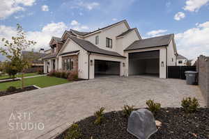 View of front facade with a garage and a front lawn