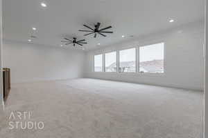 Empty room with ceiling fan and light colored carpet