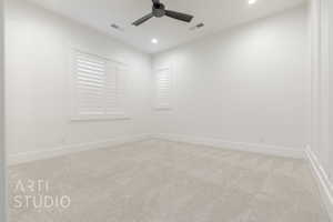 Unfurnished room with ceiling fan and light carpet