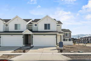 View of front of house featuring a mountain view and a garage