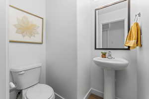 Bathroom with toilet and wood-type flooring