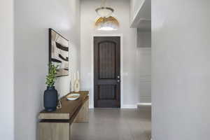 Tiled foyer entrance featuring a high ceiling