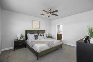 Carpeted bedroom with ceiling fan and ensuite bathroom