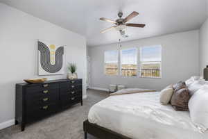 Bedroom featuring ceiling fan and carpet floors