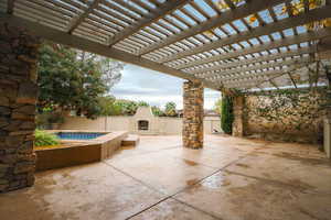 View of patio / terrace featuring an outdoor fireplace