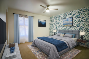 Carpeted bedroom featuring ceiling fan