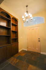 Entryway with a notable chandelier