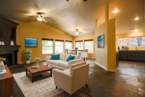 Living room with a healthy amount of sunlight, sink, lofted ceiling, and a fireplace