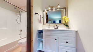 Full bathroom with shower / bathing tub combination, vanity, and toilet