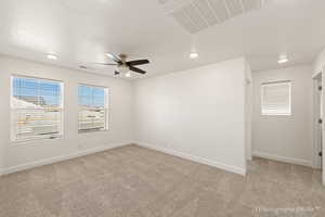 Unfurnished room with ceiling fan and carpet floors