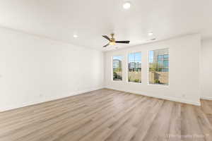 Spare room with ceiling fan and light hardwood / wood-style flooring