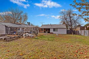 Back of house with a lawn