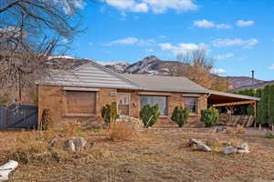 Single story home with a carport and a mountain view