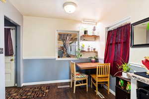 Dining room with dark hardwood / wood-style flooring