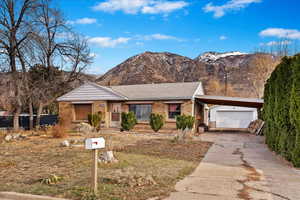 Single story home with a mountain view and a carport