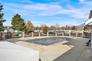 View of swimming pool with a mountain view and a patio