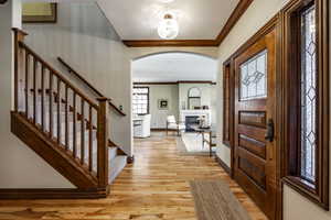 Entrance foyer featuring light hardwood / wood-style flooring and ornamental molding