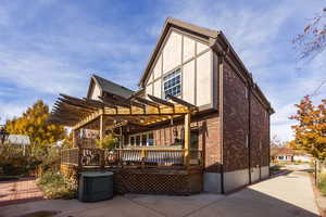 Exterior space featuring a pergola and a wooden deck