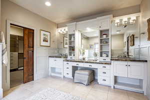 Bathroom with tile patterned flooring and vanity