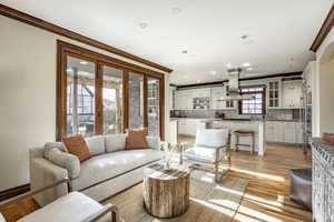 Living room featuring light hardwood / wood-style floors and crown molding