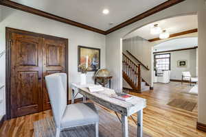 Home office featuring light wood-type flooring and ornamental molding