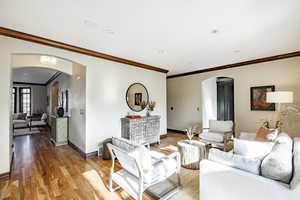 Living room featuring hardwood / wood-style flooring and ornamental molding