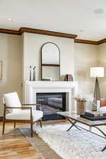 Sitting room featuring hardwood / wood-style flooring and ornamental molding