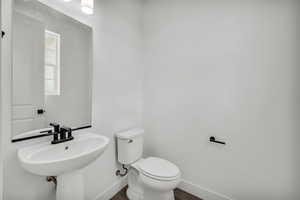 Bathroom with hardwood / wood-style flooring and toilet