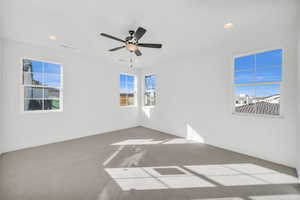 Spare room featuring carpet floors and ceiling fan