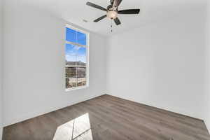 Unfurnished room featuring hardwood / wood-style flooring and ceiling fan