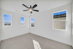 Spare room with carpet flooring and ceiling fan