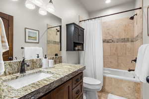 Upstairs Guest Bathroom!  Large Size Tub!  Travertine Floor & Showers!  Granite Counter Top w/ Mitered Edge!  Toilet Paper/ Storage Cabinet!