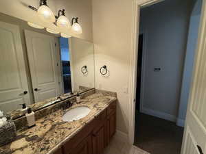 Bathroom featuring tile patterned flooring and vanity