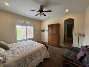 Carpeted bedroom with ceiling fan