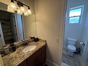 Bathroom featuring vanity and toilet