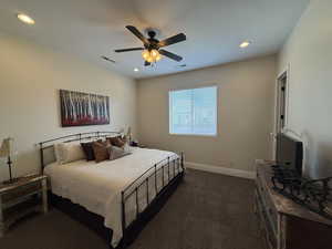 Carpeted bedroom featuring ceiling fan