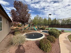 View of jungle gym featuring a trampoline