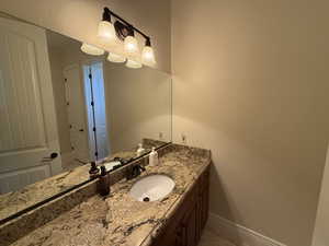 Bathroom with tile patterned floors and vanity