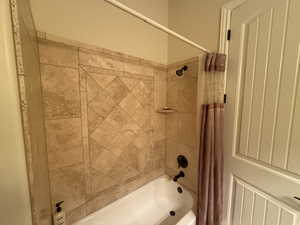 Bathroom featuring shower / tub combo with curtain