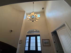 Entrance foyer with a high ceiling and an inviting chandelier